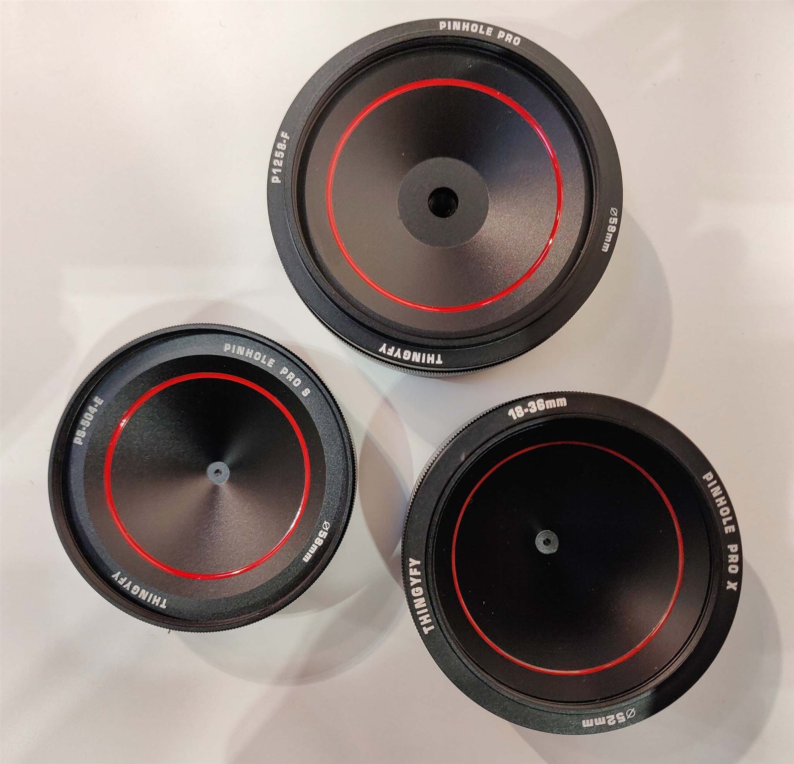 pinhole pro lens family — machined aluminum, black-and-white product shot